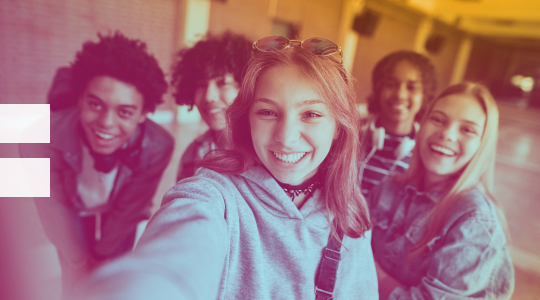 Young people posing for a selfie, all smiles.
