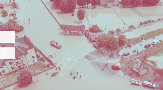 A flooded area with people and cars.