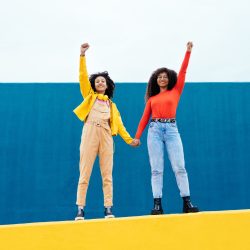 young-happy-women-posing-on-colored-blue-and-yello-2022-05-01-23-37-55-utc